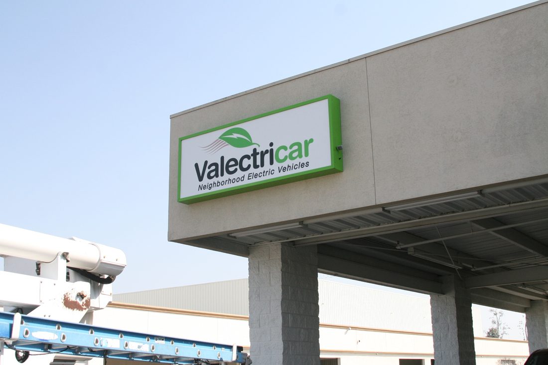 Illuminated cabinet sign on a gas station canopy